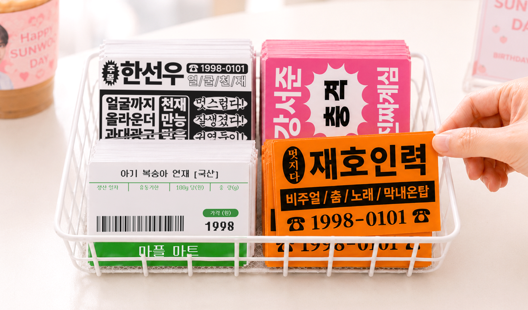 마플 찌라시 스티커 – 인력·마트·주목 찌라시 디자인으로 제작한 아이돌 팬굿즈 스티커 여러 장을 와이어 바스켓에 담아 놓은 이미지